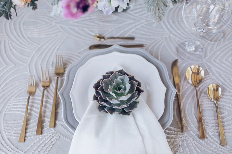gold flatware and succulents at wedding table setting