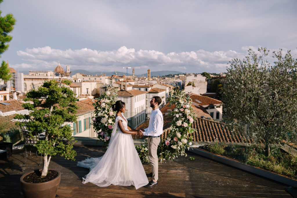 A wedding ceremony on the roof of the building, with cityscape views of the city and the Cathedral of Santa Maria Del Fiore