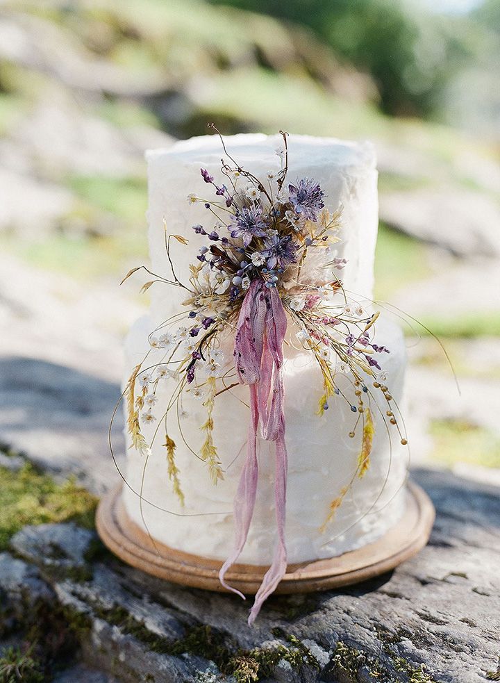 small wedding cake with wildflowers and purple ribbon for lesbian elopement