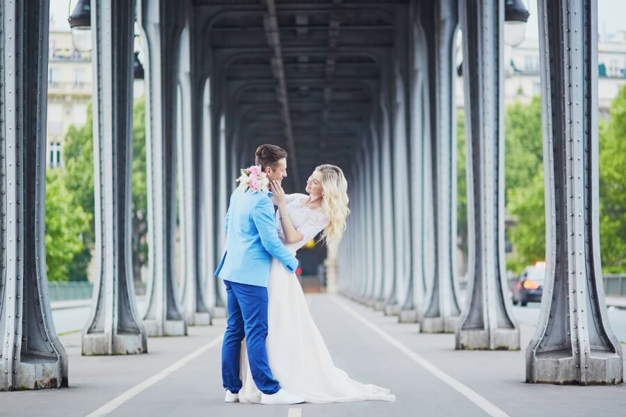 eloping in style bride and groom pose for photos under bridge