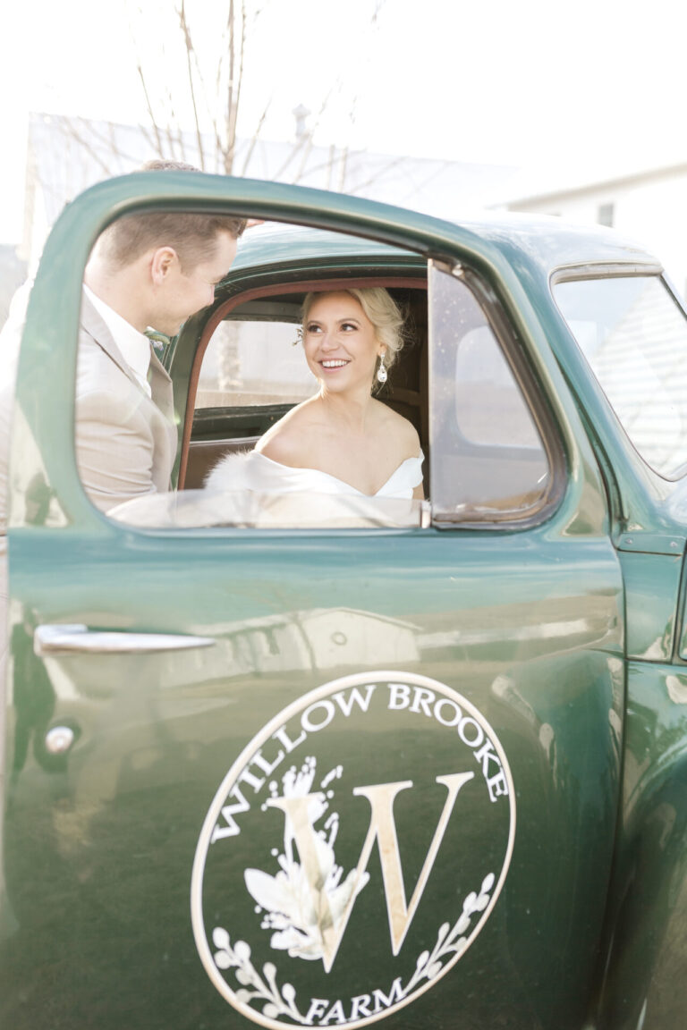 vintage green truck with bride and groom