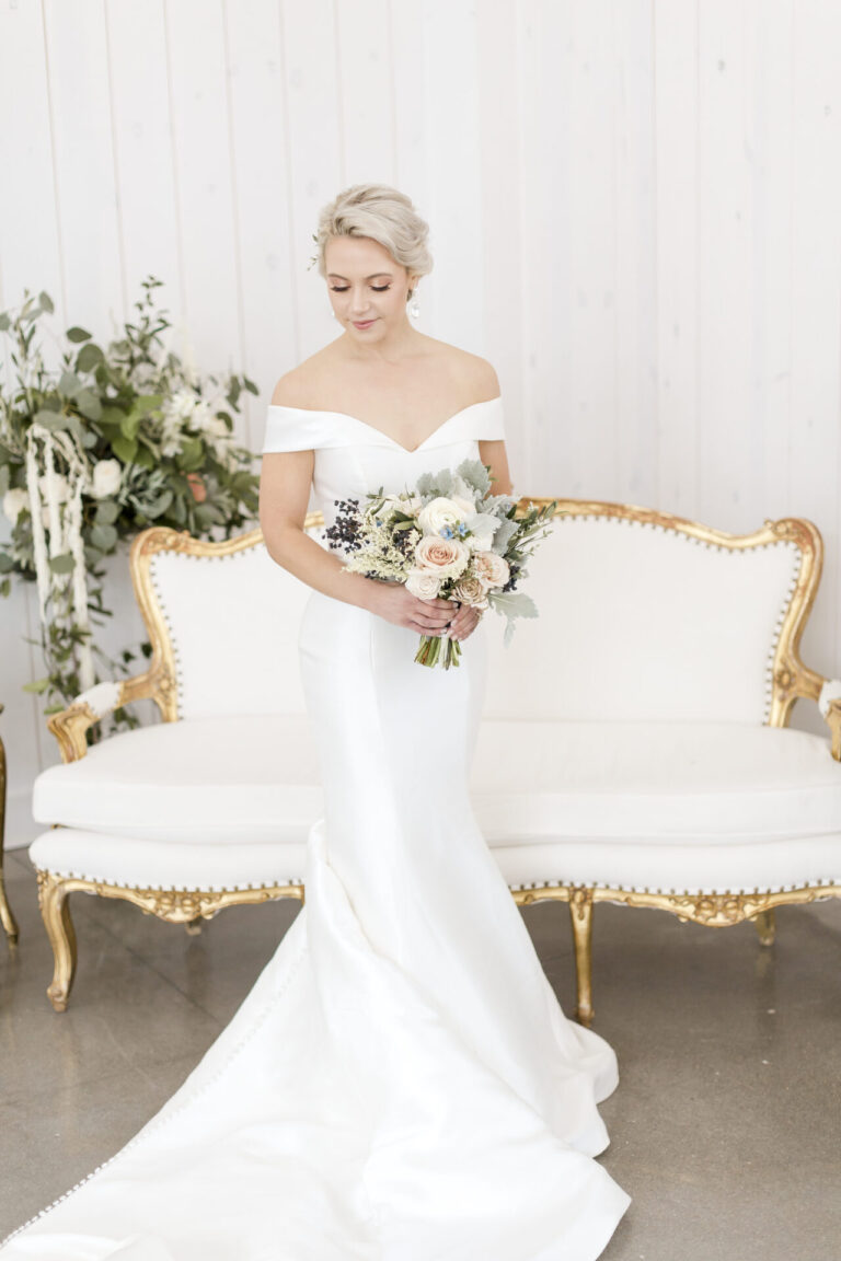 Stunning bridal portrait with vintage couch in rustic white barn at Willow Brooke Farm