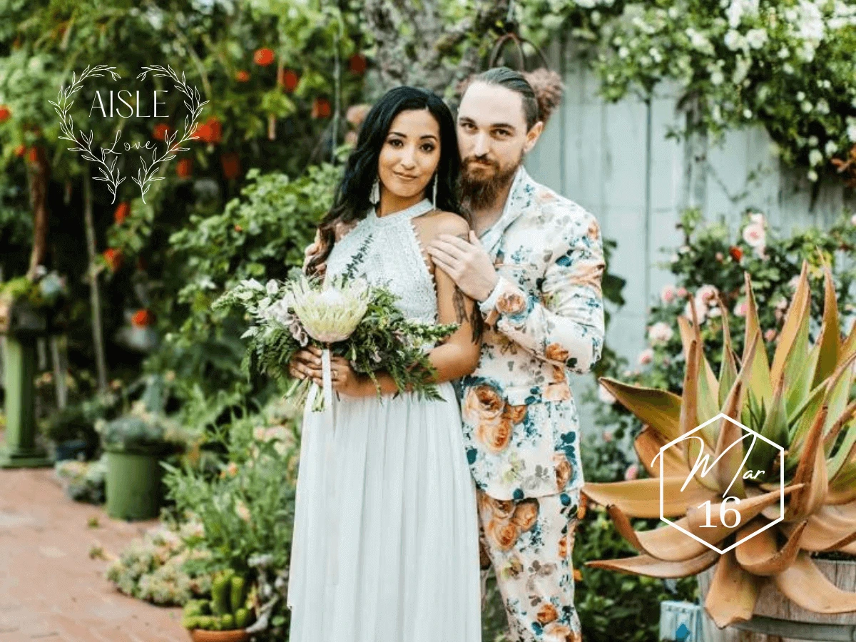 Groom wearing floral print suit with beautiful bride in outdoor boho portrait
