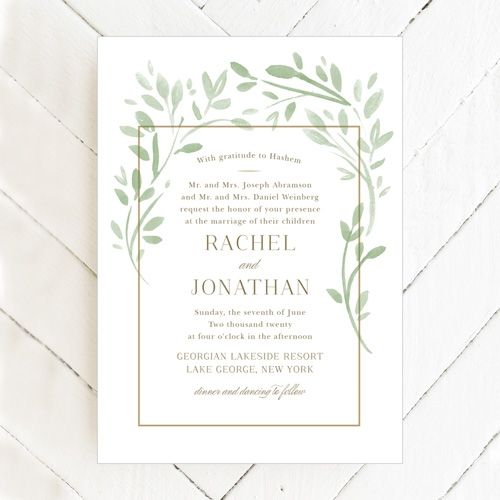 elegant white wedding invitation with greenery
