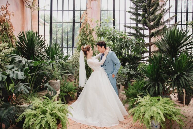 bride and groom pose in indoor botanical garden a beautiful unique wedding venue