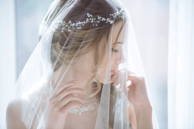bride wearing caged veil over her face for bridal portrait