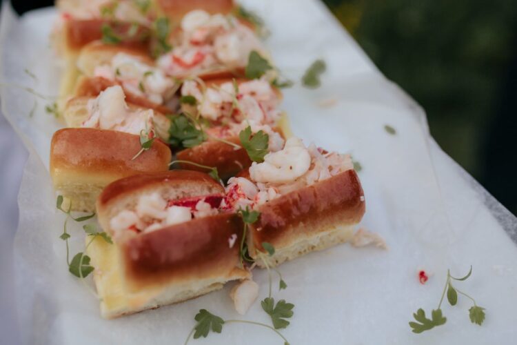 mini lobster rolls with herbs on white plate unique wedding menu
