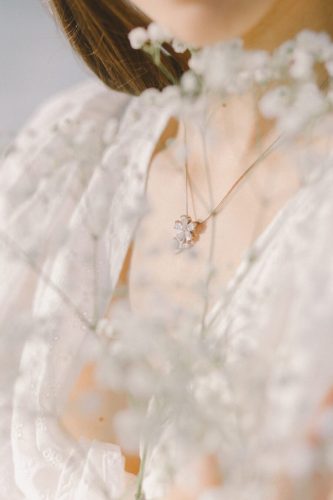 Up close photo of brides lace dress with babys breathe
