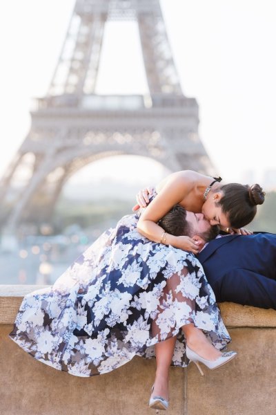 couple kissing in front of Eiffel Tower in Paris